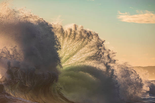 istock Powerful display of ocean waves colliding creating pattern in early morning golden light 1471529820