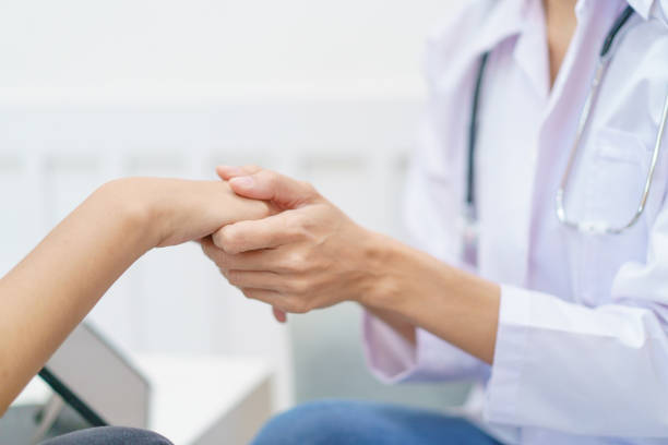 istock Doctor talking with patient in clinic. 1471530676