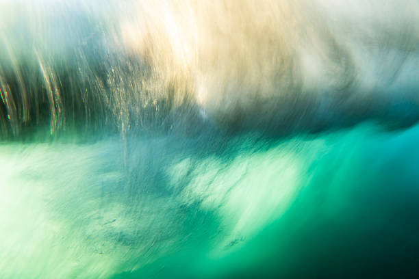 istock An abstract artistic scene of a wave breaking underwater in dramatic golden light 1471530743