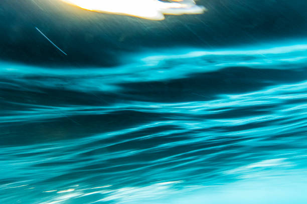 istock An abstract artistic scene of a wave breaking underwater in dramatic light 1471530767