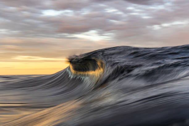istock An abstract artistic scene of a wave breaking in dramatic golden light 1471530835