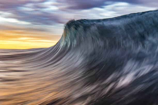 istock An abstract artistic scene of a wave breaking in dramatic golden light 1471530838