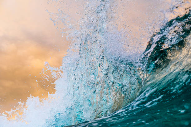 istock Ocean waves crashing under a dramatic golden sky at sunset 1471531186