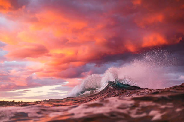 istock Ocean waves colliding creating unique water pattern under a dramatic pink and gold sky at sunset 1471531228
