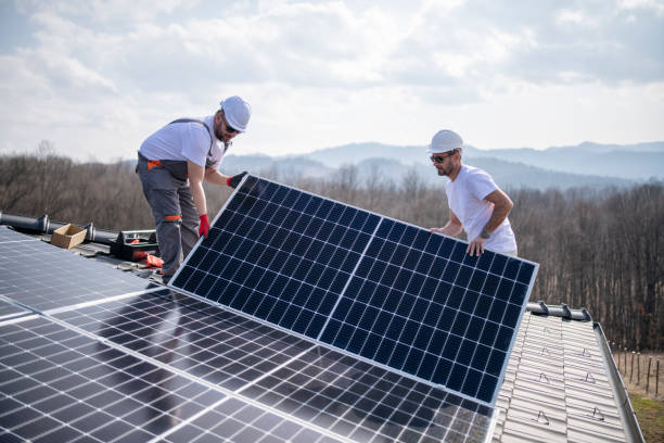 istock Two workers on a roof installing solar panels. 1471533391
