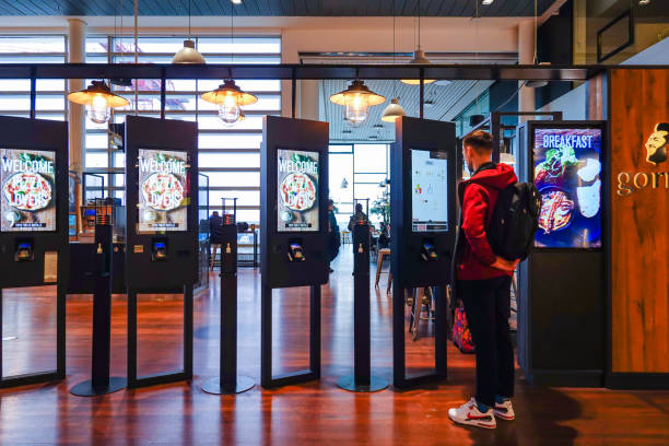 Copenhagen, Denmark Copenhagen, Denmark Feb 22, 2023 A man orders food from display screens at a restaurant,. kiosk stock pictures, royalty-free photos & images