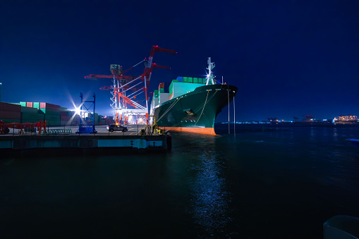 Night cranes near the container port in Tokyo. High quality photo. Koto district Aomi Tokyo Japan 01.13.2023 It is a container port in Tokyo.