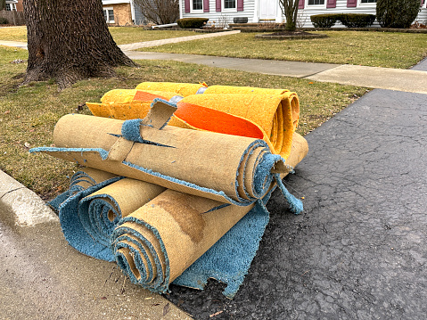 Carpet on curb waiting for garbage pick up