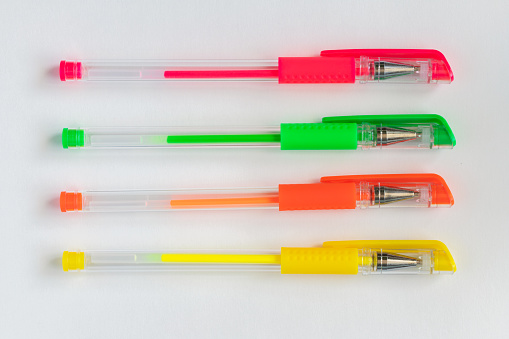 Colorful neon colors gel pens on white background