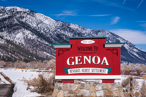 Genoa, Nevada - February 10, 2023: Welcome to Genoa sign with Sierra Nevada Mountains in the background.