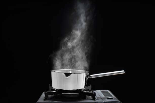 istock Steam over cooking pot in kitchen on dark background. 1471548127