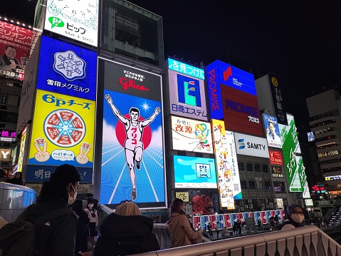 Osaka, Japan-March 5 2023: Glico sign A large display device is brightly lit among the modern architecture, creating a captivating billboard for all to see. Dotonbori Glico Sign