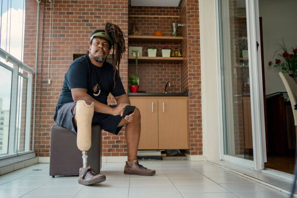 istock Portrait of man with leg prosthesis using smart phone at home 1471554264