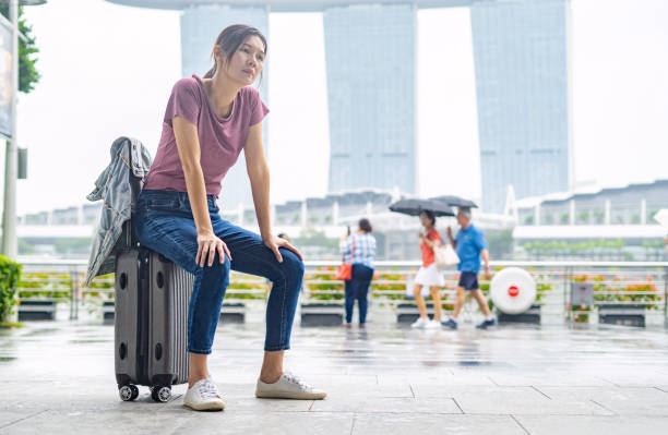 istock Woman sitting on suitcase , resting for  while. 1471555109
