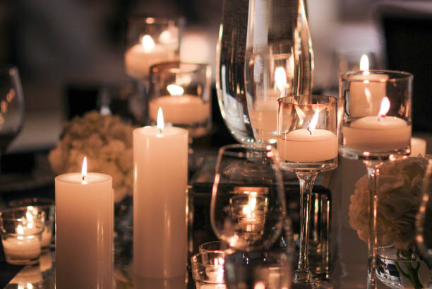 istock Elegant candle lit dinner with glowing flames over luxury silverware and fancy wine glasses for event dinner for a festive dining experience 1471556426
