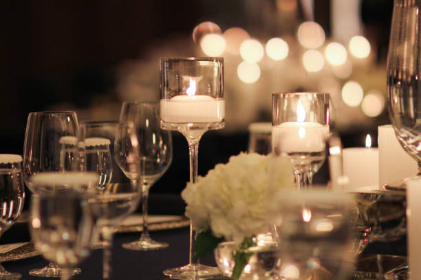 istock Elegant candle lit dinner with glowing flames over luxury silverware and fancy wine glasses for event dinner for a festive dining experience 1471556427