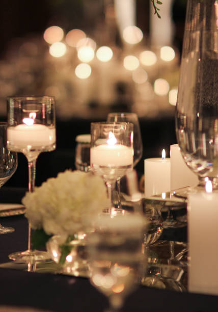 istock Elegant candle lit dinner with glowing flames over luxury silverware and fancy wine glasses for event dinner for a festive dining experience 1471556461
