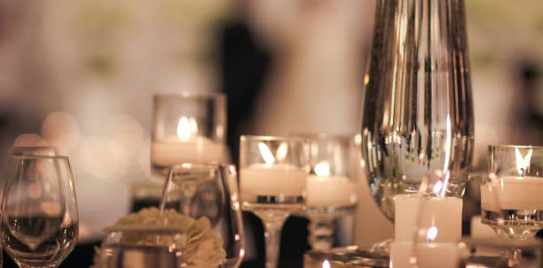 istock Elegant candle lit dinner with glowing flames over luxury silverware and fancy wine glasses for event dinner for a festive dining experience 1471556467