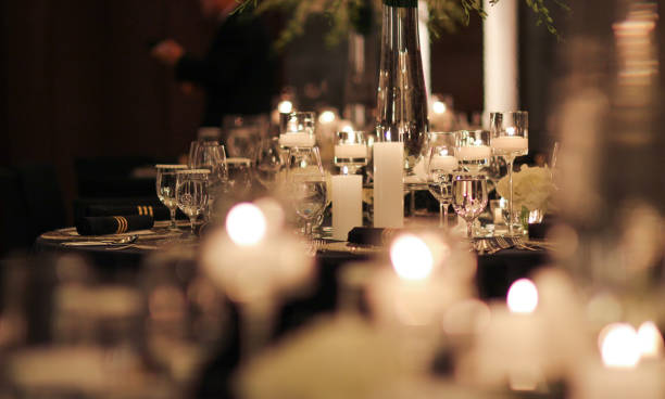 istock Elegant candle lit dinner with glowing flames over luxury silverware and fancy wine glasses for event dinner for a festive dining experience 1471556471