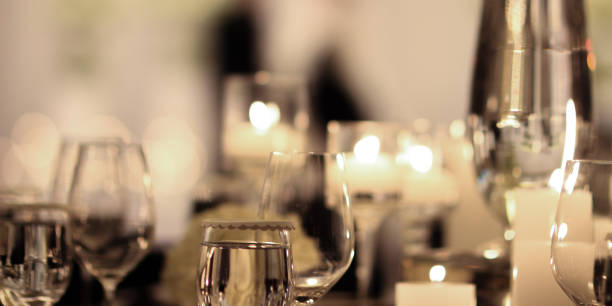 istock Elegant candle lit dinner with glowing flames over luxury silverware and fancy wine glasses for event dinner for a festive dining experience 1471556479