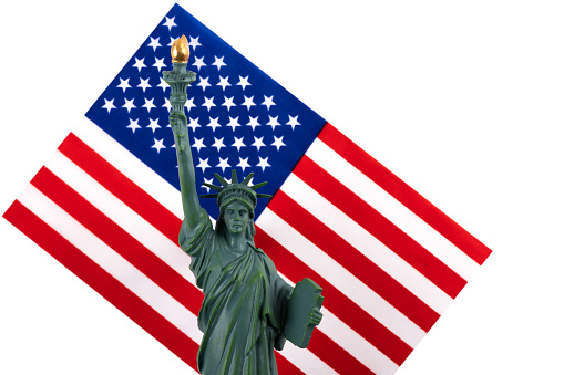 Model of the Statue of Liberty and the American flag on a white background