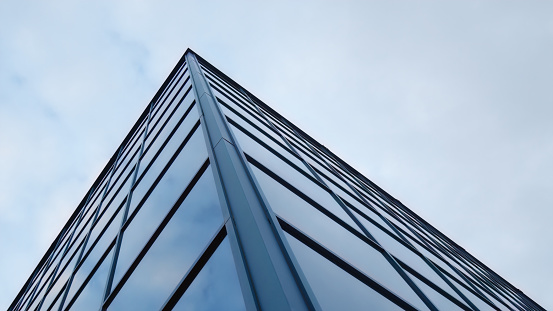 office tower glass building corner modern architecture blue skyscraper downtown city business and finance corporation