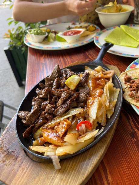 istock Meat with cabbage in a pan on a stand stands on a table in a restaurant 1471563656