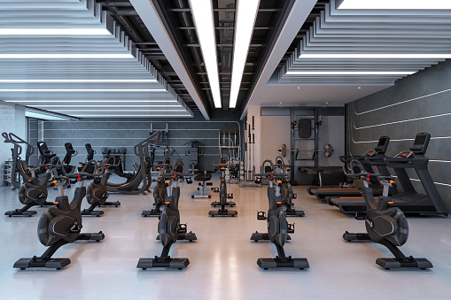 Modern Gym Interior With Exercise Bikes, Treadmills, Halters And Sports Equipments