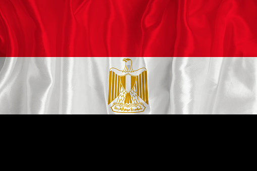 The flag of Egypt on a silk background is a great national symbol. Fabric texture The official state symbol of the country.