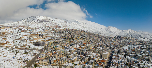 Winter snow covering Hermon mountain and town houses of Majdal Shams