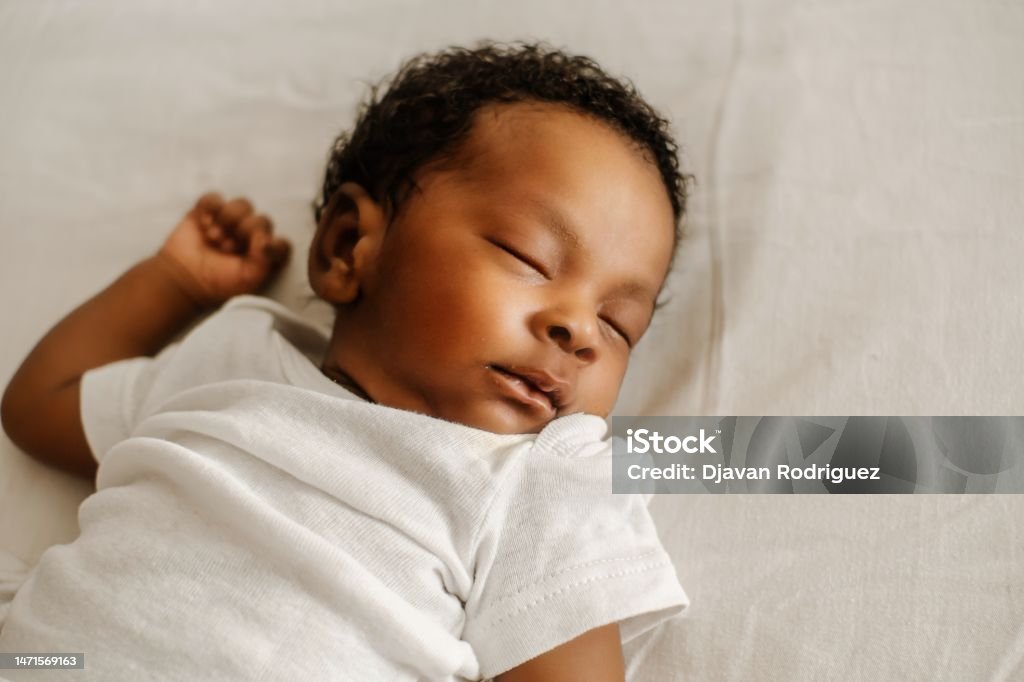 newborn sleep in the bed. Baby - Human Age Stock Photo
