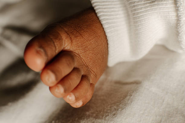 istock a tiny feet of baby child. 1471569168