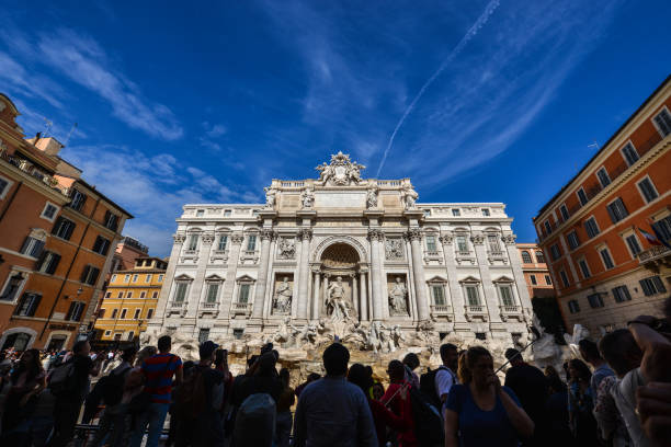 Rome, Italy - Oct 15, 2018. People visit Trevi Fountain in sunny day. Trevi is one of the most famous fountains in the world.