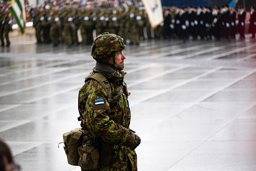 Estonian soldier commander is leading a platoon marching during the military parade due to a national holiday Anniversary of the Republic of Estonia.