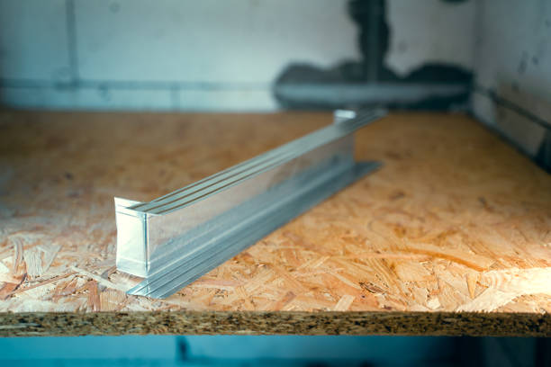 Jumper from a metal profile for a frame wall. Prepared stiffener for plasterboard wall. The metal U profile is cut and prepared lies on the osb panel close-up