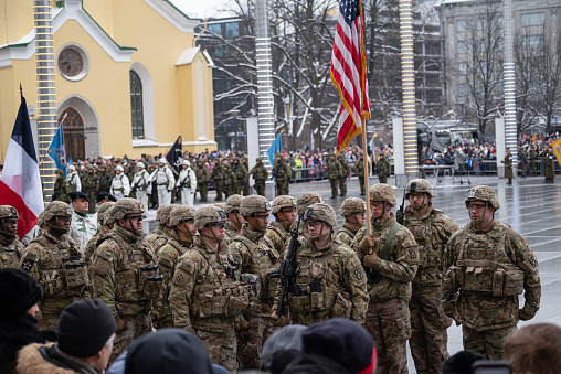 American military armed forces holding the US flag, Estonia's NATO ally in the Tallinn main square marching in the parade celebration of independence