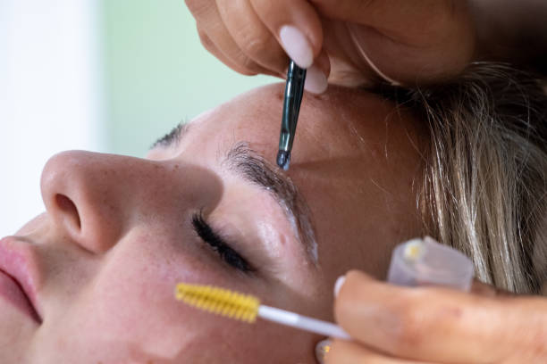 istock Hands of makeup artist apply means for laminating eyebrows 1471572814