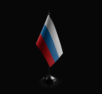 Small national flag of the Russia on a black background.