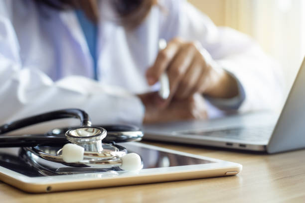 istock Female doctor work on laptop computer 1471575408
