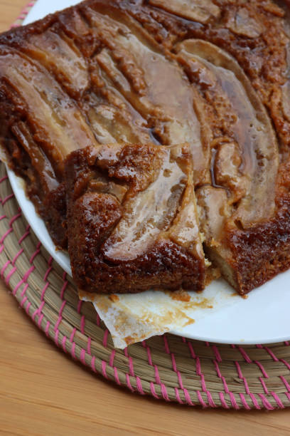 istock Upside down banana and caramel cake with slice on table 1471575629