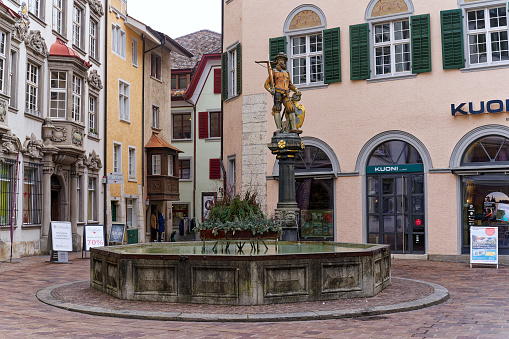 Soldier statue at fountain with crossbow weapon at the old town of Swiss City of Schaffhausen on a foggy winter day. Photo taken February 16th, 2023, Schaffhausen, Switzerland.