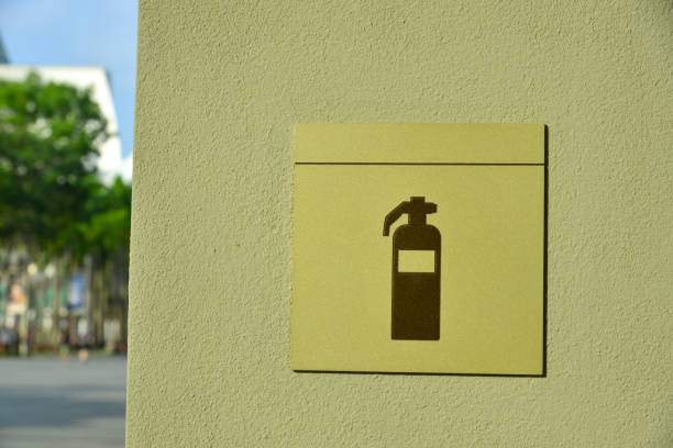 Simple fire extinguister symbol red sign, square plate, sticker on the wall, front view, frontal shot. Object closeup, nobody, fire prevention, emergency equipment abstract concept, no people