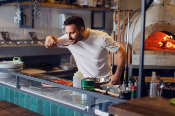 istock Young Chef Preparing Pizza In Kitchen Restaurant 1471579317