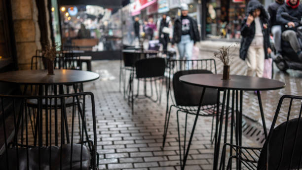 istock tables are on street focus on foreground people are walking background horizontal still 1471580418