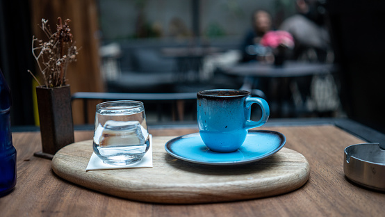 turkish coffee which in blue cup is on wooden table at cafe horizontal still