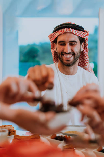 istock Modern multiethnic muslim family sharing a bowl of dates while enjoying iftar dinner together during a ramadan feast at home 1471582910