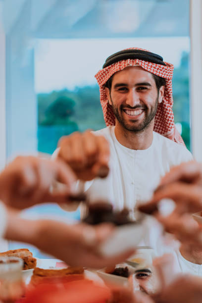 istock Modern multiethnic muslim family sharing a bowl of dates while enjoying iftar dinner together during a ramadan feast at home 1471582956