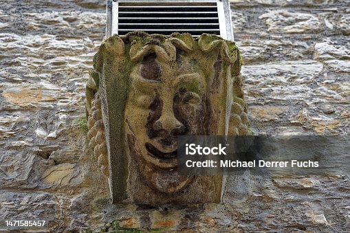istock Decoration at facade with stone face of historic house at alley at the old town of Swiss City of Schaffhausen on a foggy winter day. 1471585457
