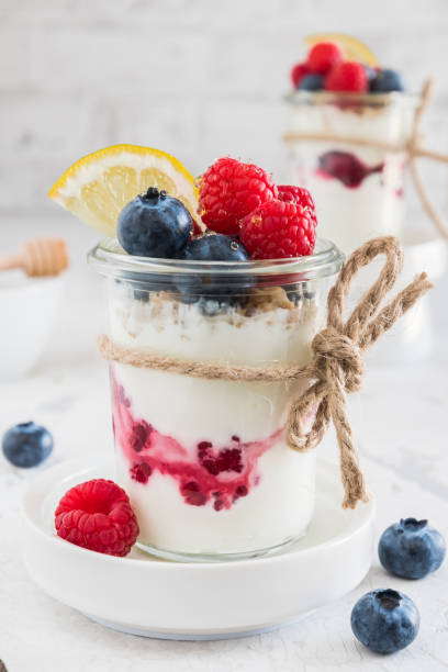 istock Yogurt with berries and cereals in a glass on white background, vertical 1471586951