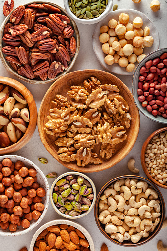 Close-up of various nuts and seeds in bowls.